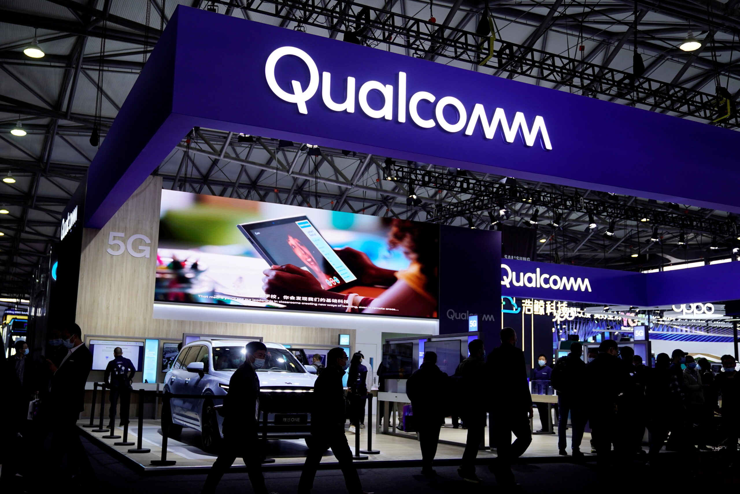 FILE PHOTO: People visit a Qualcomm booth at the Mobile World Congress (MWC) in Shanghai, China February 23, 2021.   REUTERS/Aly Song