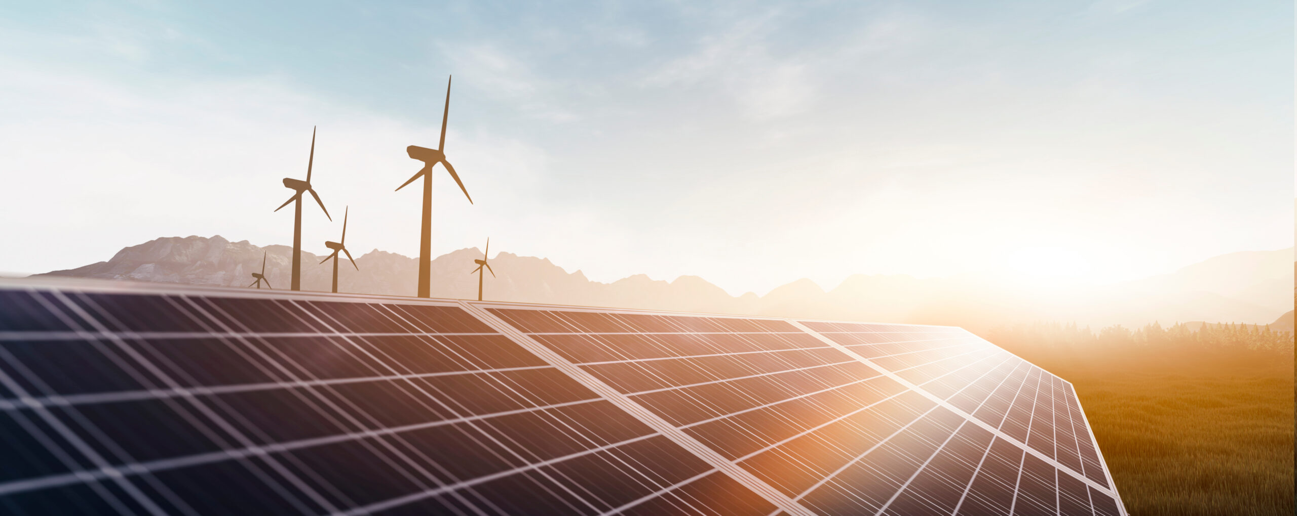 solar panels and wind power turbines in a sunset