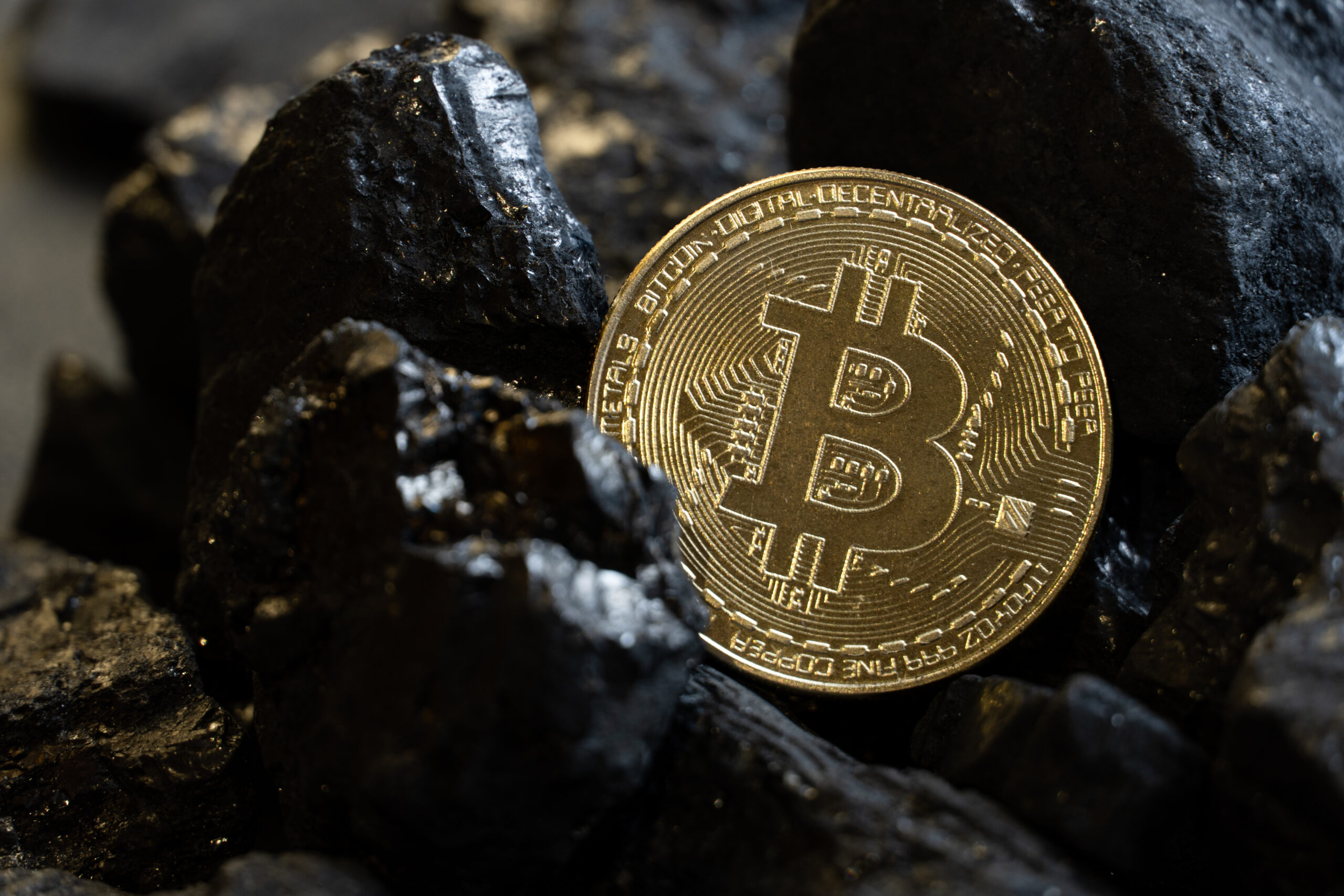 Background of gold coin bitcon and coal.