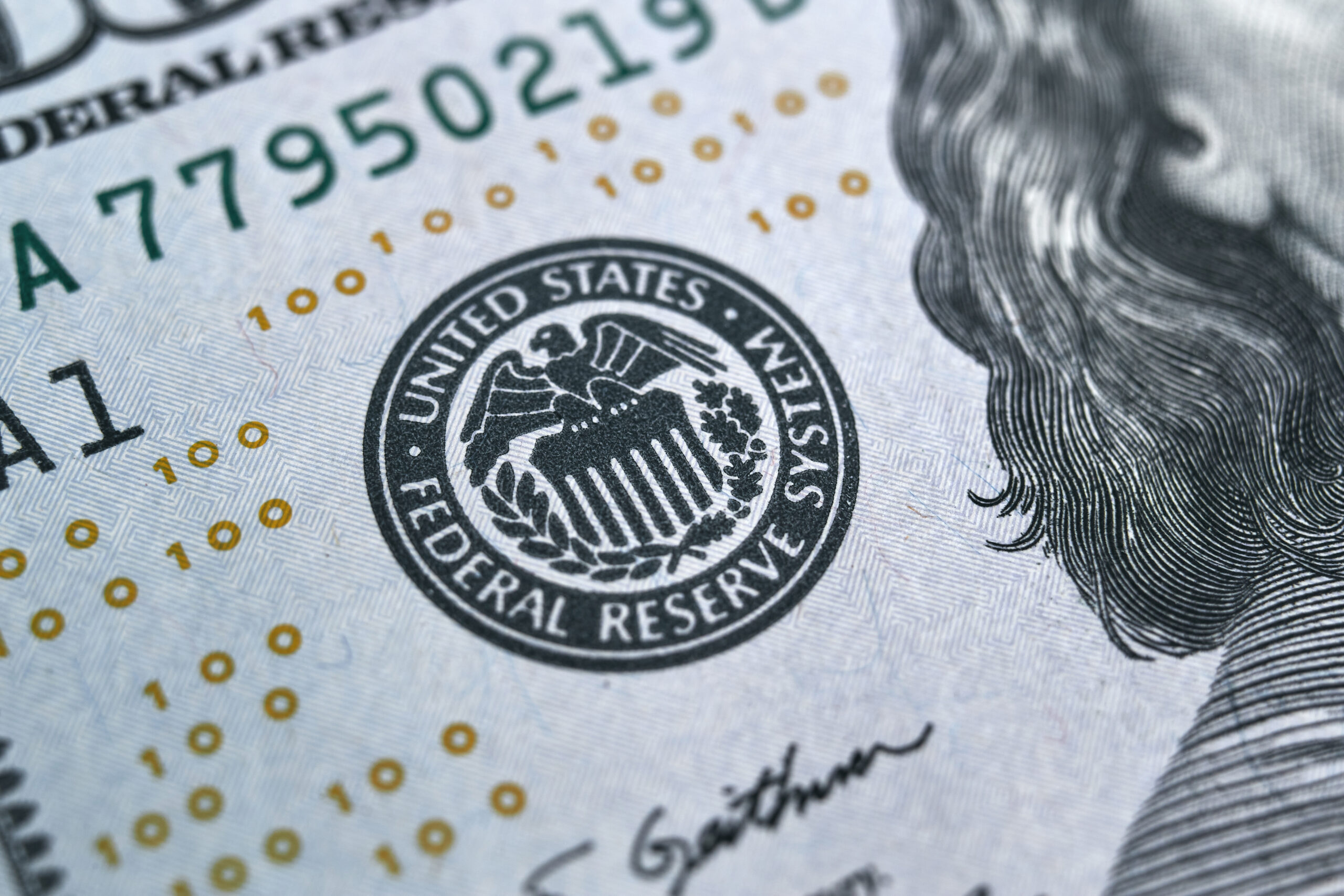 macro photo of federal reserve system symbol on hundred dollar bill. shallow focus. close-up with fine and sharp texture