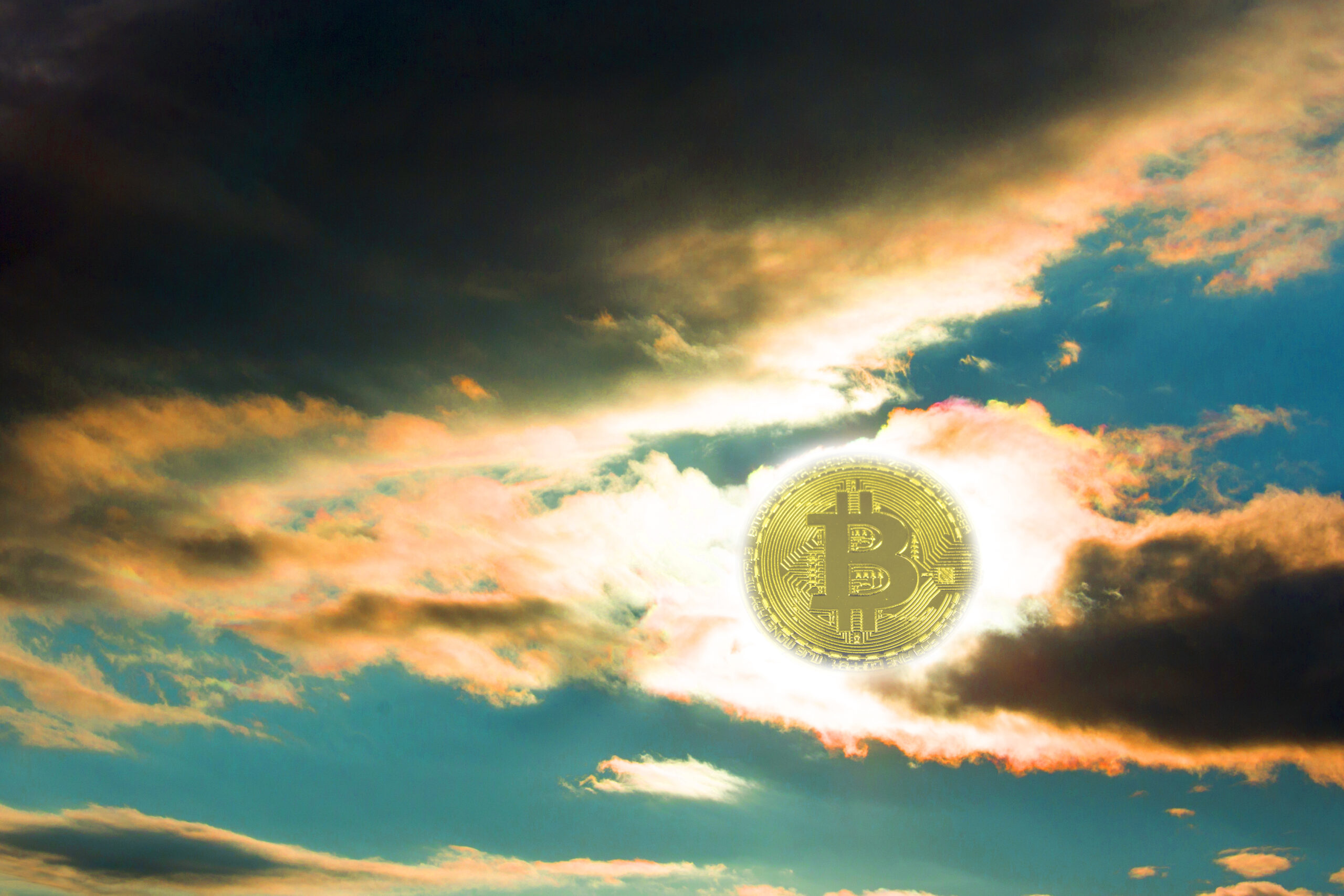 Sunset bitcoin. The fall of bitcoin. Coin bitcon instead of the sun. Yellow red sunset with dark clouds.