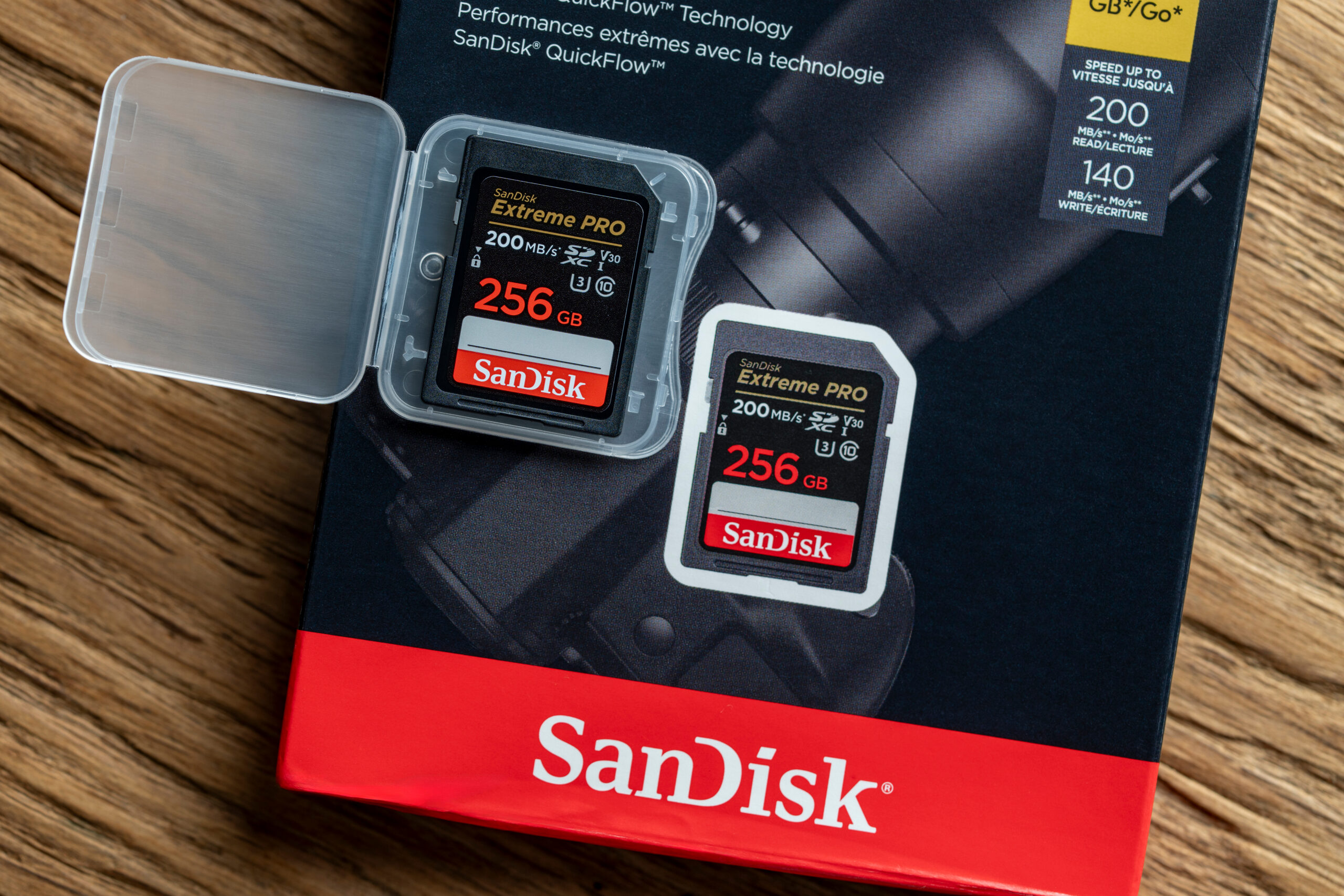 Kyiv, Ukraine - Oct 05, 2025 : memory card SanDisk Extreme Pro SDXC 256GB UHS-I U3 V30 in a plastic container and cardboard packaging on a wooden background, close up