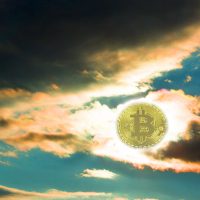 Sunset bitcoin. The fall of bitcoin. Coin bitcon instead of the sun. Yellow red sunset with dark clouds.